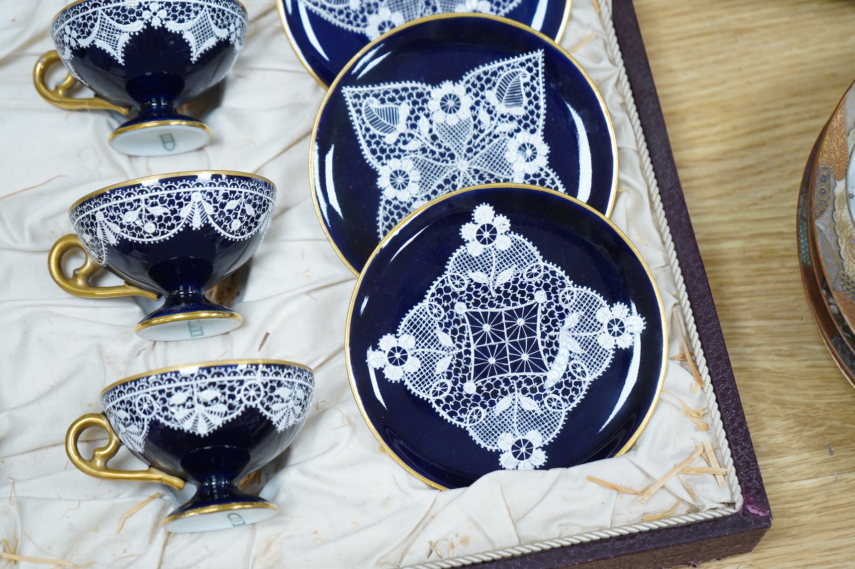 A Vienna-style lace-pattern coffee set, Beehive marks, cased